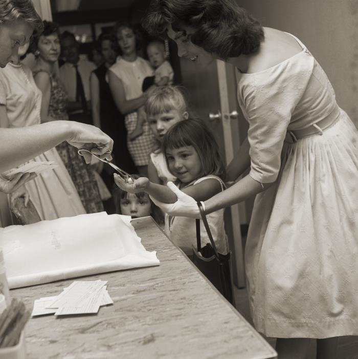 Oral polio vaccination on a sugar cube, 1961